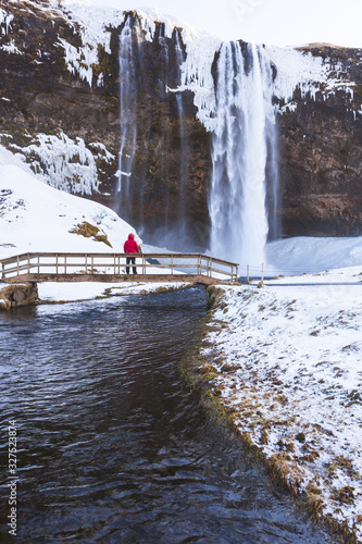 Selyalandfoss waterfall in Iceland. Tourist enjoys the view of the river cascade