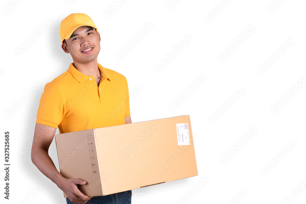 Happy delivery man in yellow polo shirt uniform holding parcel post box isolated over white background. Smiling courier Delivery man. Happy delivery man in yellow polo shirt uniform holding parcel post box isolated over white background. Smiling courier Delivery man.
