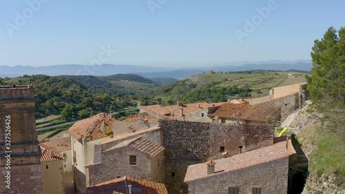 Aerial view of Culla ancient village from above: medieval church, old houses and villge buildings well perserved. Views to whole valley as background. Castellon province, Valencia, Spain photo