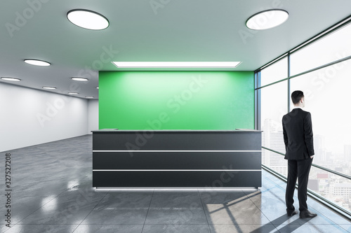 Businessman standing in office lobby hall