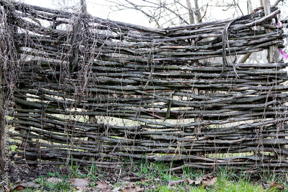A wooden wicker fence. Background A wooden wicker fence. Background
