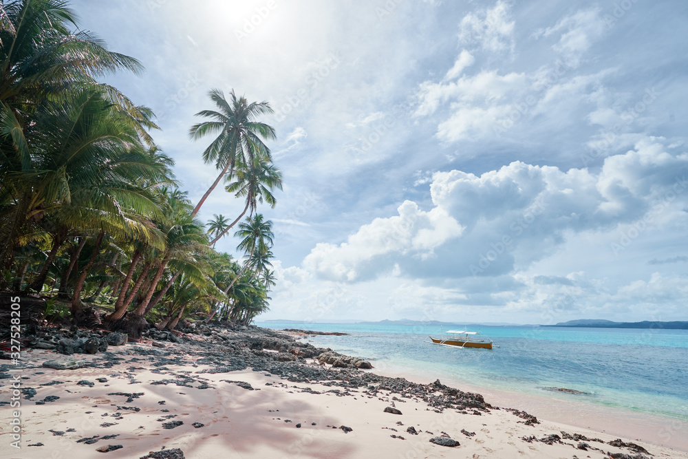 Beautiful landscape - tropical white sand beach with fishing boats. Siargao Island, Philippines. Beautiful landscape - tropical white sand beach with fishing boats. Siargao Island, Philippines.