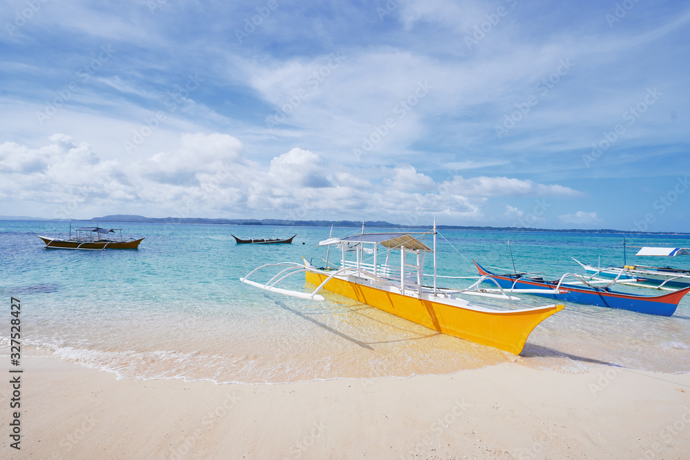 Beautiful landscape with tropical white sand beach with fishing boats. Siargao Island, Philippines. Beautiful landscape with tropical white sand beach with fishing boats. Siargao Island, Philippines.