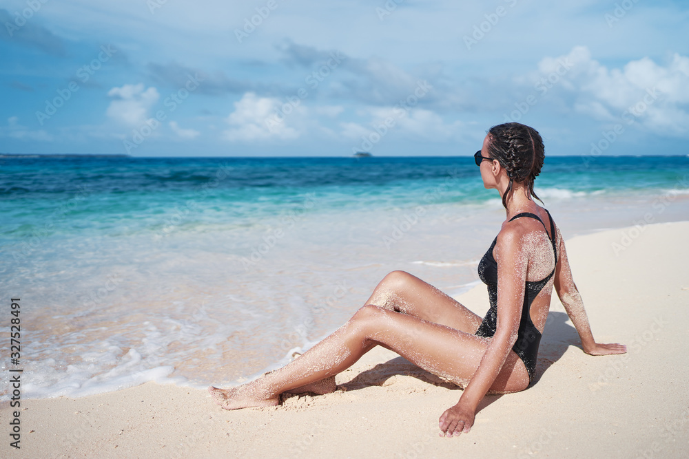 Vacation on the sea. Happy young woman enjoying suntan on the white sand beach. Vacation on the sea. Happy young woman enjoying suntan on the white sand beach.