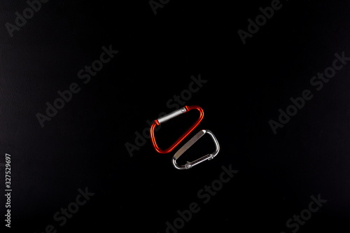 Metal carabiner isolated on a black background in full size. photo