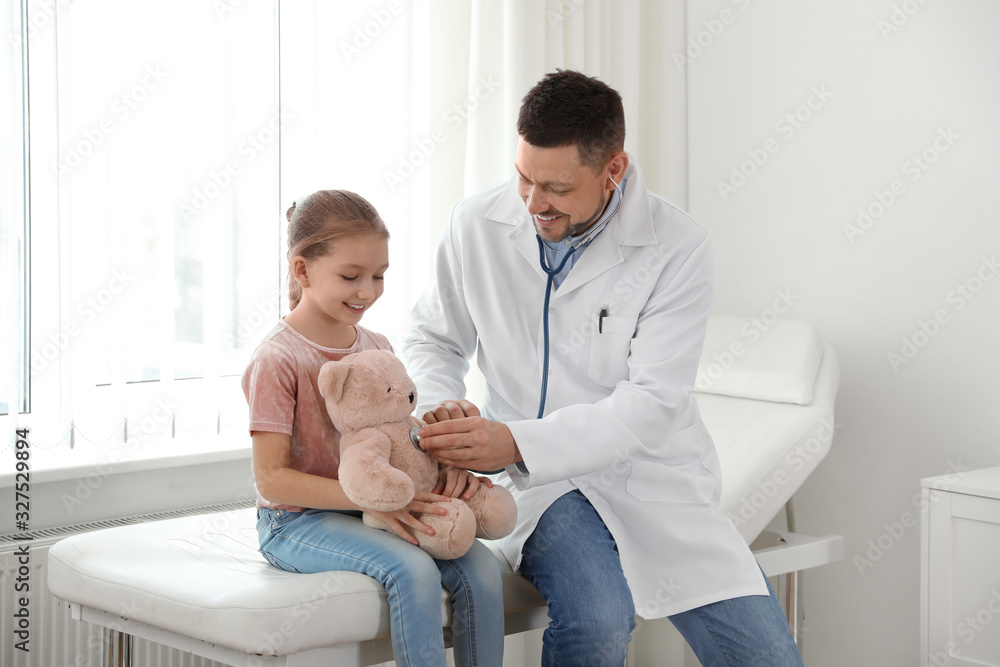 Children's doctor working with little patient in clinic Children's doctor working with little patient in clinic
