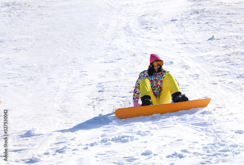 Young woman snowboarding on hill. Winter vacation © New Africa