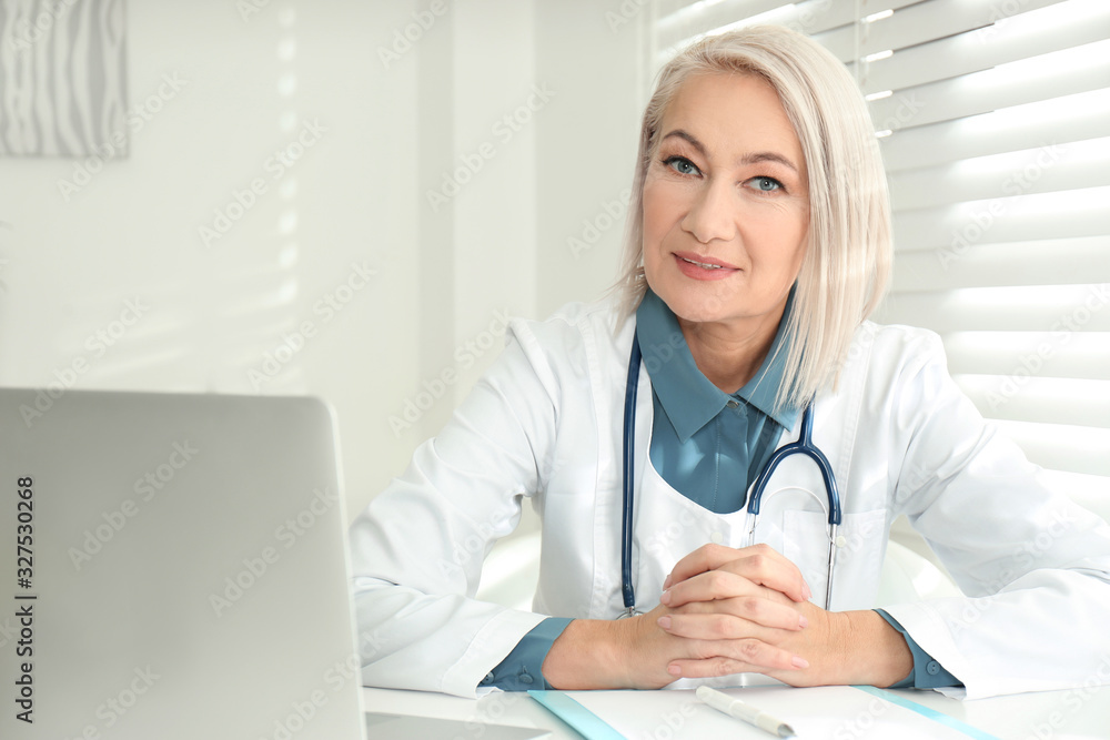 Portrait of mature female doctor in white coat at workplace Portrait of mature female doctor in white coat at workplace