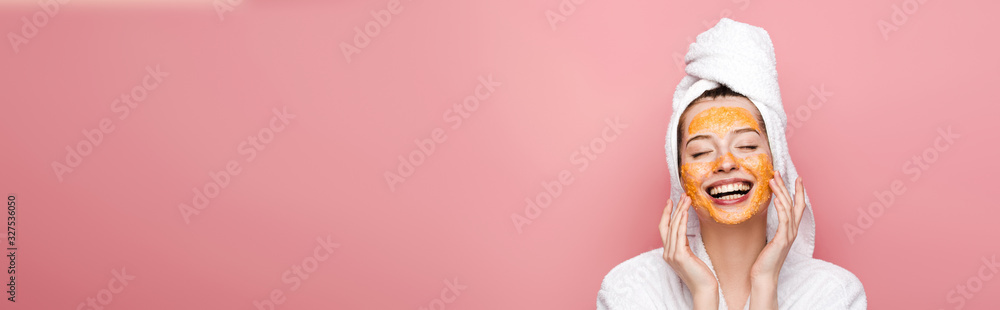 panoramic shot of happy girl with citrus facial mask touching face with closed eyes isolated on pink - obrazy, fototapety, plakaty 