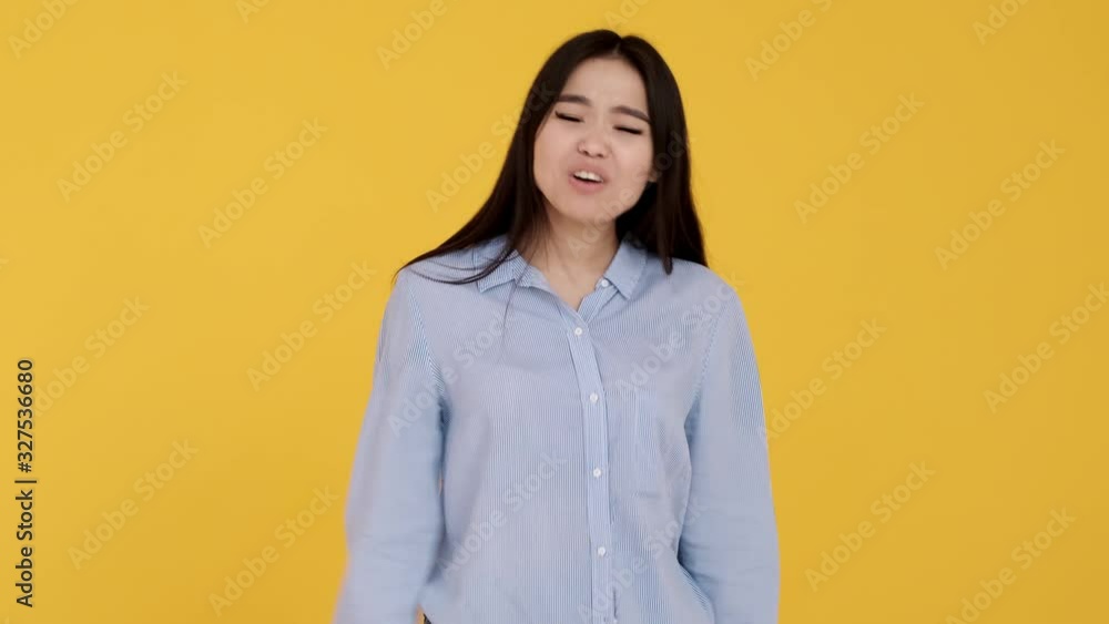 Asian Girl on a yellow background. not consent and denial . woman screaming no Asian Girl on a yellow background. not consent and denial . woman screaming no