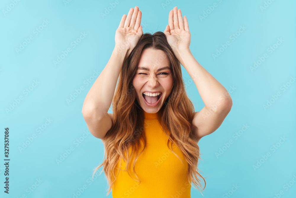 Portrait of beautiful woman smiling and gesturing bunny ears with hands Portrait of beautiful woman smiling and gesturing bunny ears with hands