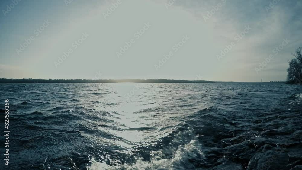 waves of the dark blue river illuminated by bright daylight waves of the dark blue river illuminated by bright daylight