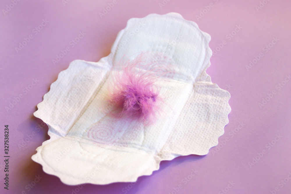 Menstrual pads and tampons on menstruation period calendar with on lilac background. Menstrual pads and tampons on menstruation period calendar with on lilac background.