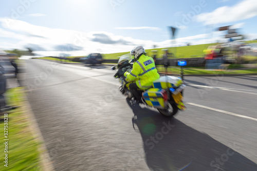 British police motorcycle traveling at high speed with motion blur