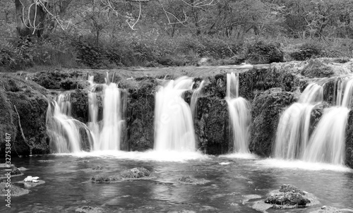 Black and white image of a waterfall in Lathkill Dale  Derbyshire England