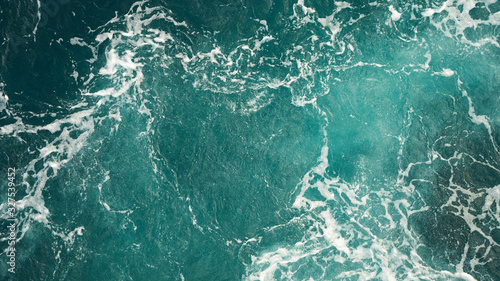 Background of the sea, clean deep ocean with air bubbles, foam on the surface of the ocean. foam composition on blue turquoise water.