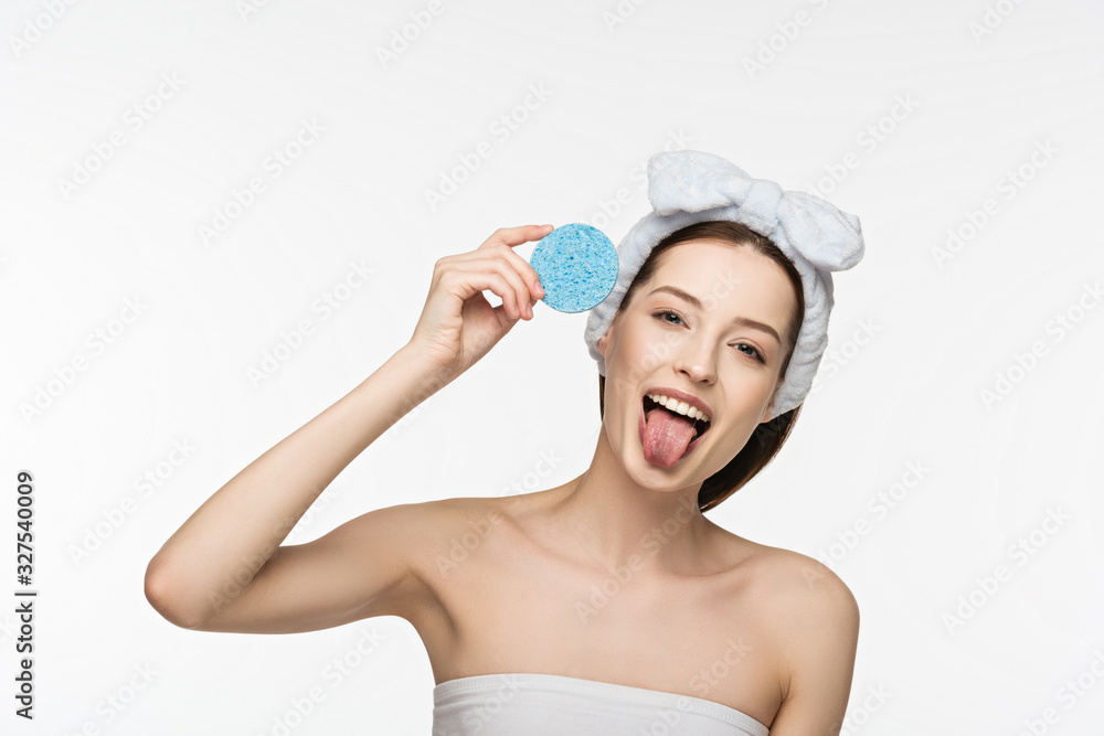 cheerful girl holding colorful cosmetic sponges and sticking out tongue isolated on white cheerful girl holding colorful cosmetic sponges and sticking out tongue isolated on white