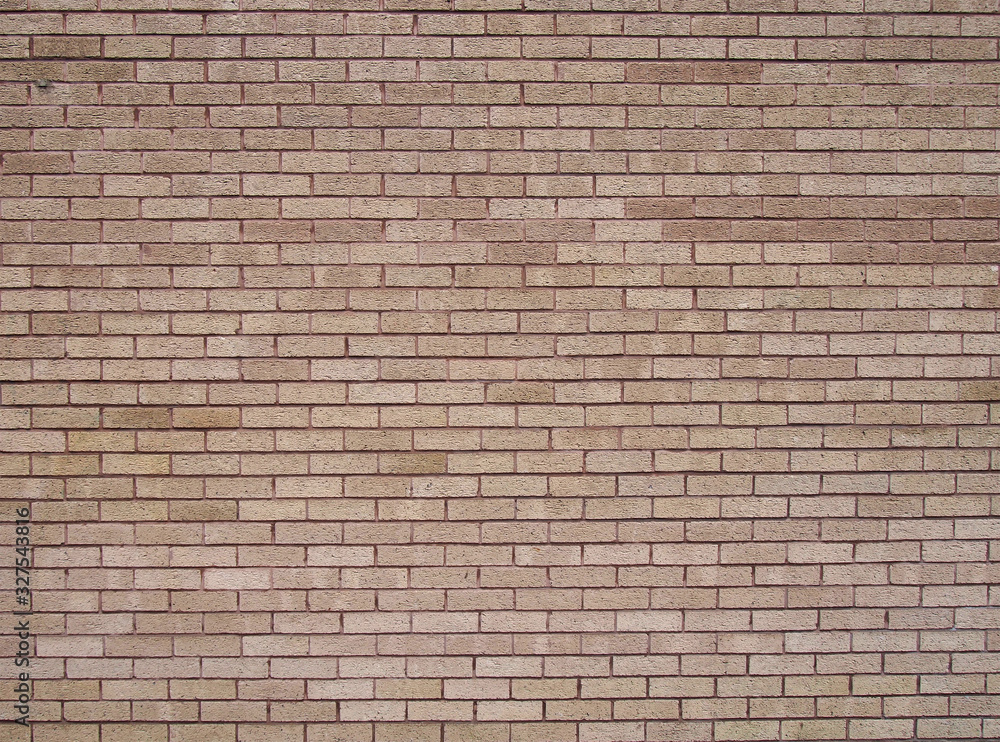 a full frame light brown textured brick wall background a full frame light brown textured brick wall background