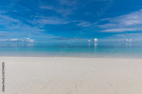 Tropical beach view. Calm and relaxing empty beach scene  blue sky and white sand. Tranquil nature concept