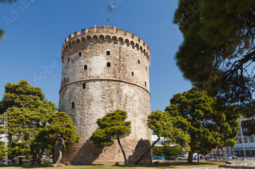 THESSALONIKI, GREECE - SEPTEMBER 10, 2018: The White Tower and greenery around photo