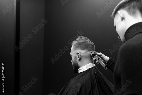 Haircut men typewriter close-up. Barber cuts a man.