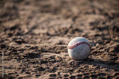 Front view of baseball in dirt