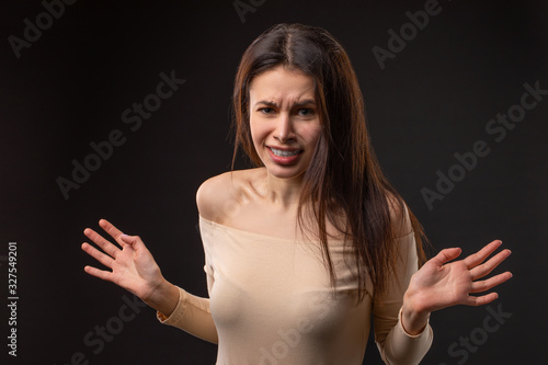 Closeup photo portrait of unsatisfied tired crying woman on black background