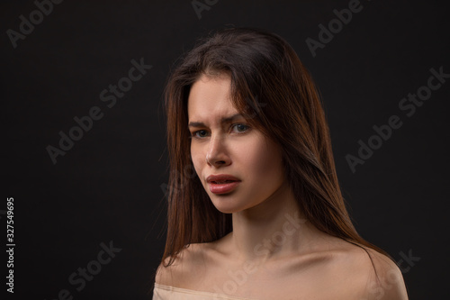 Closeup photo portrait of unsatisfied tired crying woman on black background