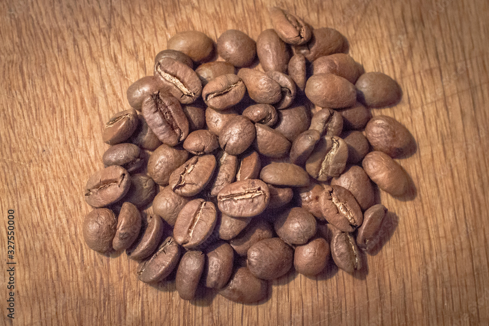 A handful of coffee beans. Grade Arabica. Hot coffee drink. Strong espresso. Grains of medium frying. The menu in the coffee shop. Fragrant drink. Coffee bean close-up. An invigorating morning drink. A handful of coffee beans. Grade Arabica. Hot coffee drink. Strong espresso. Grains of medium frying. The menu in the coffee shop. Fragrant drink. Coffee bean close-up. An invigorating morning drink.