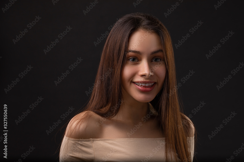 Sarcasm emotion Brunette girl portrait against black background Sarcasm emotion Brunette girl portrait against black background