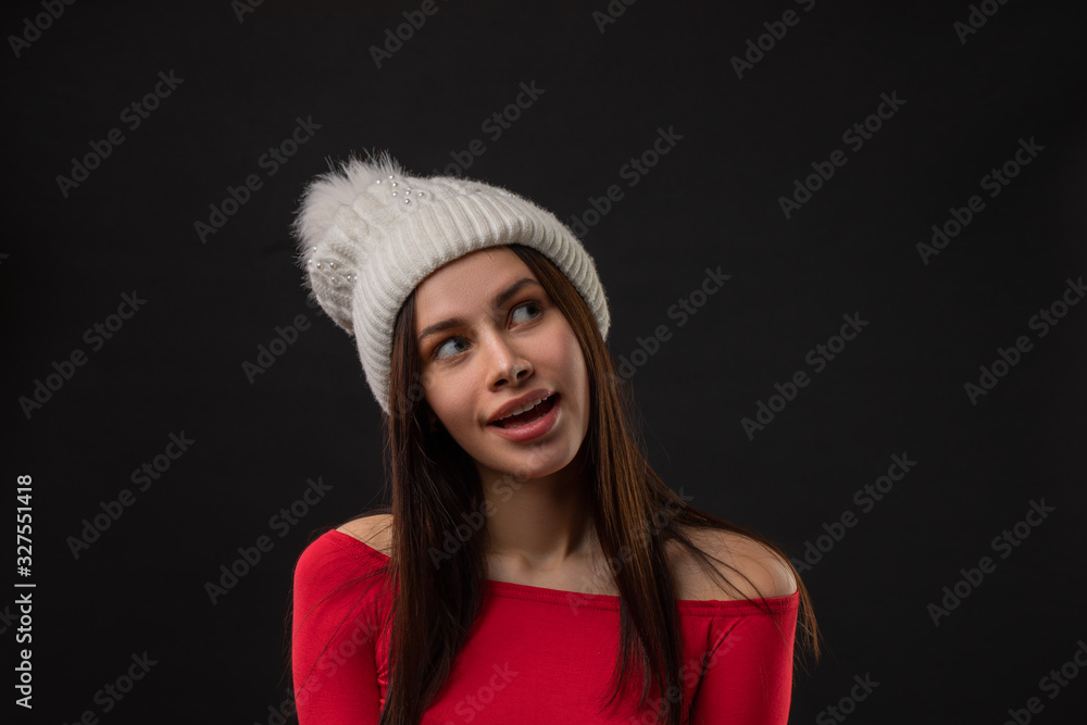 woman modern hipster portrait smiling happy and confident looking at camera on black background wearing knit hat. woman modern hipster portrait smiling happy and confident looking at camera on black background wearing knit hat.