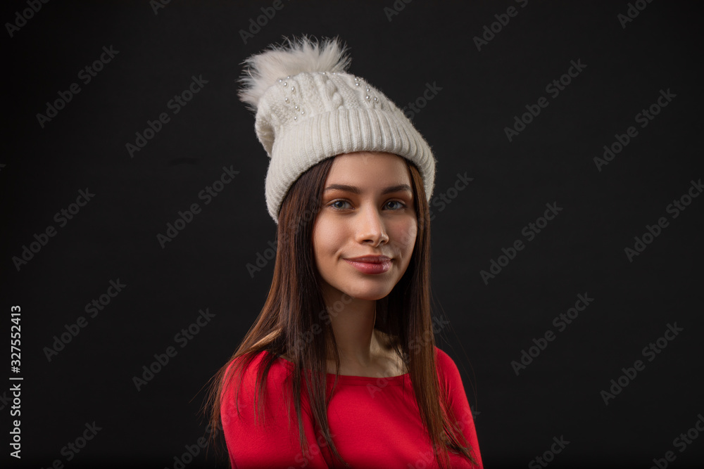 woman modern hipster portrait smiling happy and confident looking at camera on black background wearing knit hat. woman modern hipster portrait smiling happy and confident looking at camera on black background wearing knit hat.