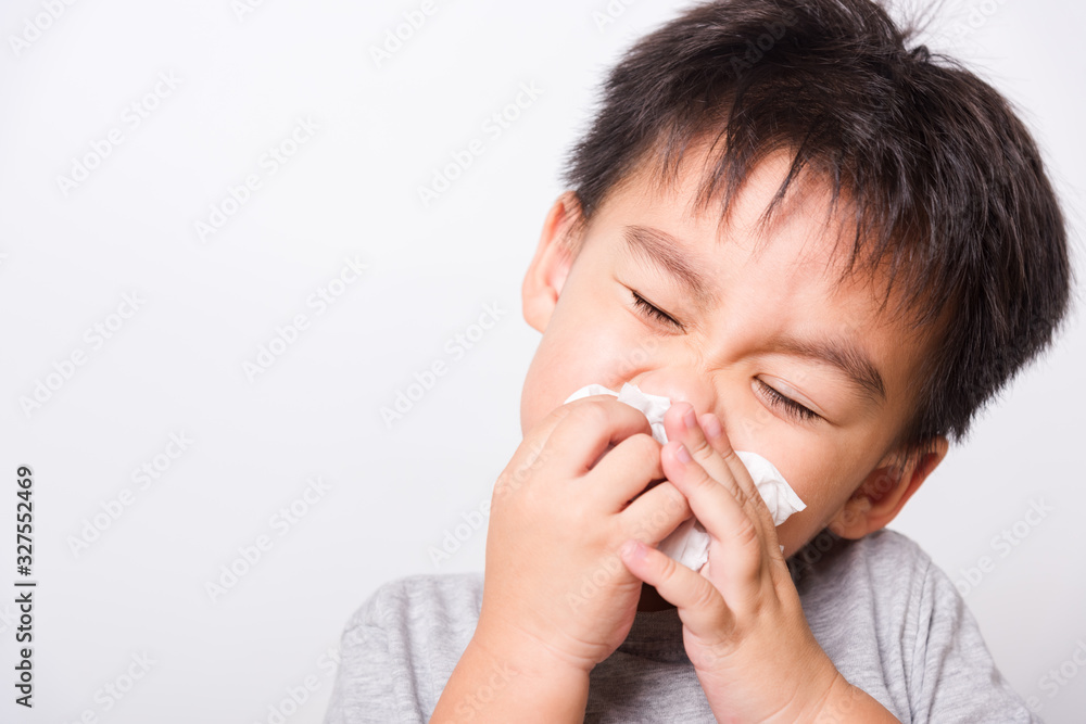 Closeup Asian face, Little children boy cleaning nose with tissue Closeup Asian face, Little children boy cleaning nose with tissue