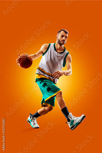 bright professional basketball player on an orange background © 103tnn