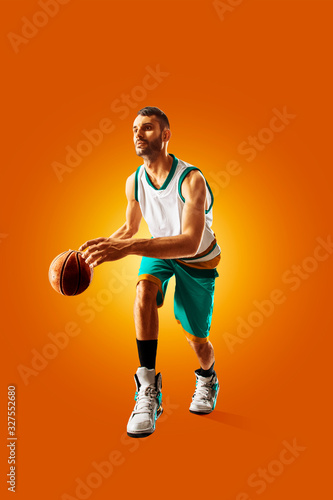 bright professional basketball player on an orange background © 103tnn