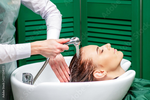 Close up washing hair of woman.