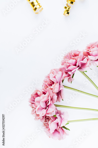 White background with peony flowers and confetti  top view