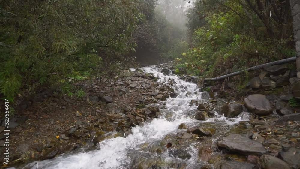 Seething clean clear mountain river waterfall flowing slow motion Seething clean clear mountain river waterfall flowing slow motion