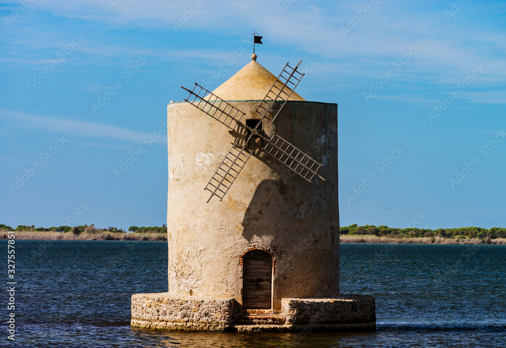Old windmill in italy, tuscany. Standing in the water