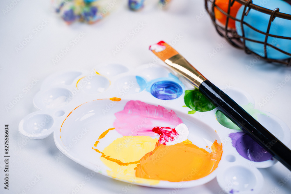 Design concept - Preparing for Easter celebration, painting Easter eggs with colorful Acrylic pigment color dyestuff in palette, close up, lifestyle. Design concept - Preparing for Easter celebration, painting Easter eggs with colorful Acrylic pigment color dyestuff in palette, close up, lifestyle.