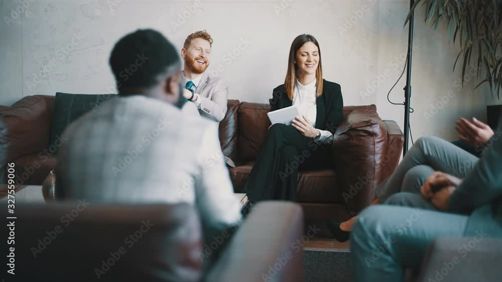 Business people sitting in a hotel lobby and working remotely Business people sitting in a hotel lobby and working remotely