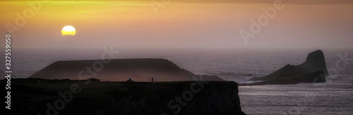 Sunset at Worms Head at Rhossili Bay on the far end of the Gower peninsula, Swansea, South Wales, UK