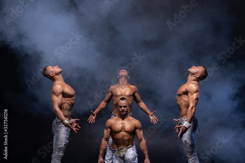 Four muscular gothic man standing shirtless on black background. Concept of mystery and secret photo