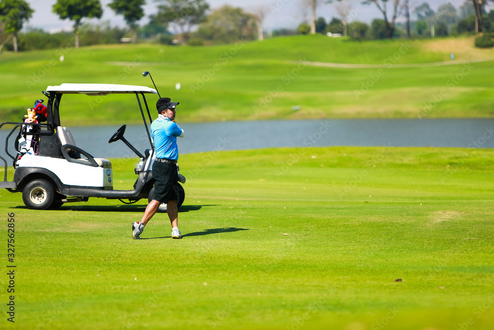 Professinal golf player on golf course. Pro golfer taking a shot Professinal golf player on golf course. Pro golfer taking a shot