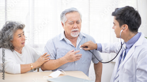 Doctor using stethoscope for auscultate Asian grandfather patient while older woman take care of him, service Life insurance, healthcare with Long live and Elderly society, Prevent epidemic concept