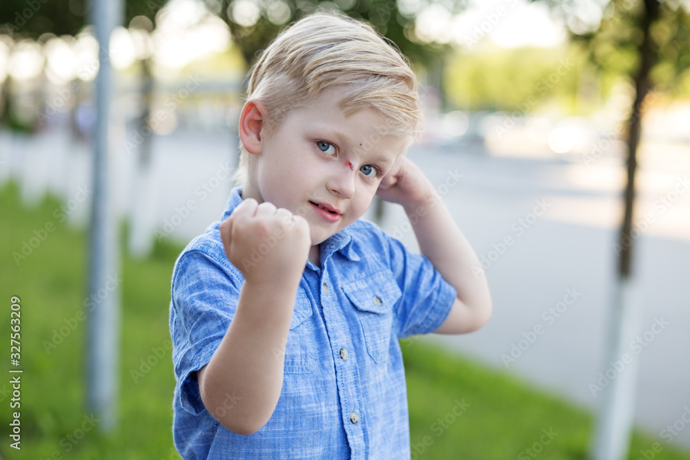 Naughty child fights and threatening fists. The concept of childhood, parenting and care Naughty child fights and threatening fists. The concept of childhood, parenting and care