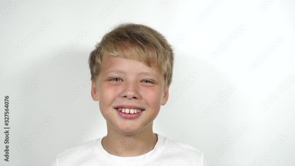 Closeup view 4k video portrait of smiling happy cute funny white kid. Teeth with overbite need braces correction. Closeup view 4k video portrait of smiling happy cute funny white kid. Teeth with overbite need braces correction.