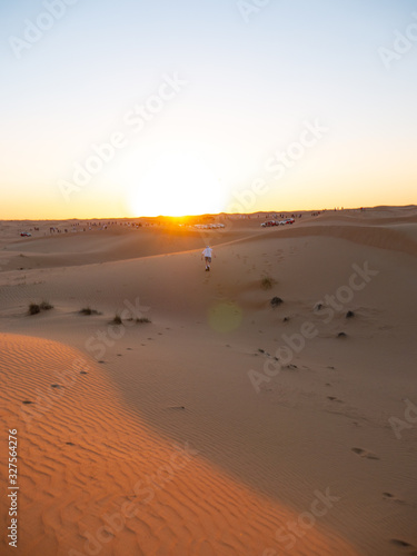 Person on sand dunes in dubai UAE summer