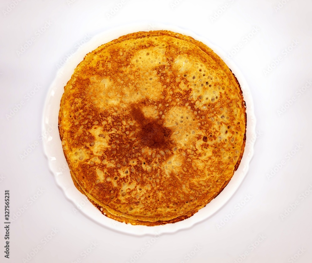 Top view of the holiday treat. There are pancakes in a white round plate Top view of the holiday treat. There are pancakes in a white round plate