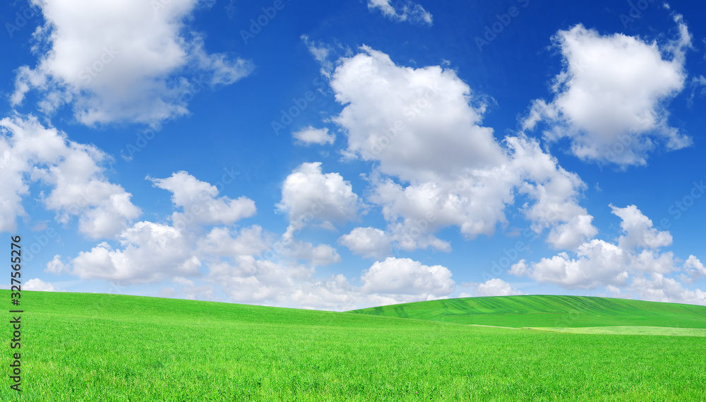 Idyllic view, green hills and blue sky with white clouds Idyllic view, green hills and blue sky with white clouds
